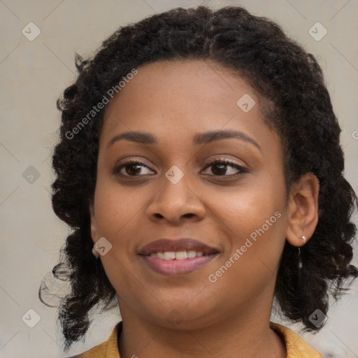 Joyful black young-adult female with long  brown hair and brown eyes