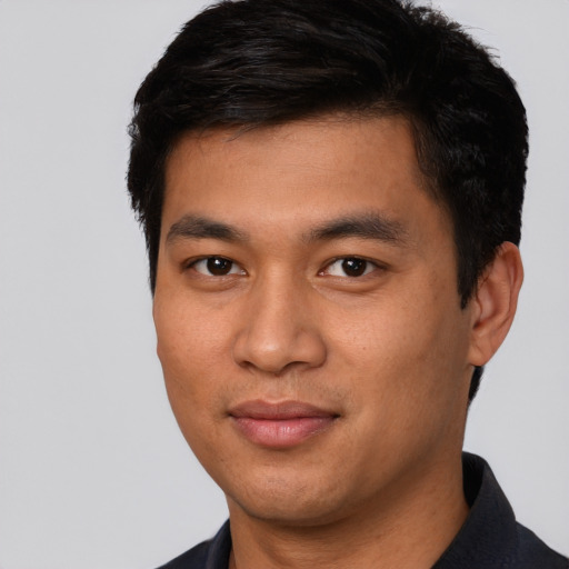 Joyful asian young-adult male with short  brown hair and brown eyes