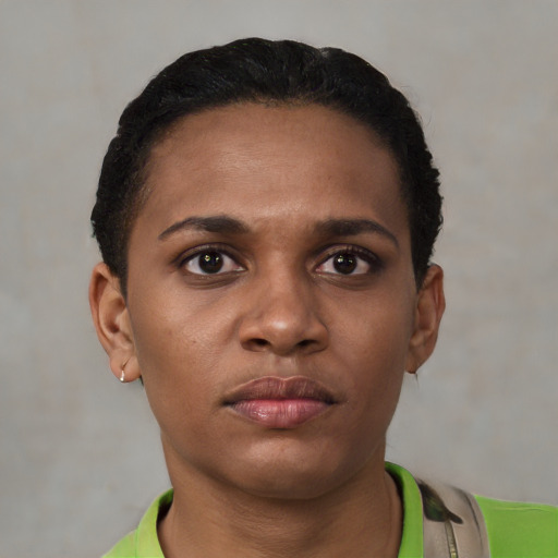 Joyful latino young-adult female with short  black hair and brown eyes