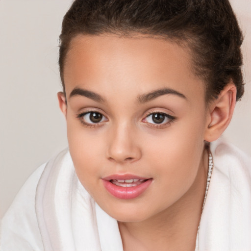 Joyful white child female with short  brown hair and brown eyes