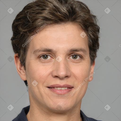 Joyful white adult male with short  brown hair and grey eyes