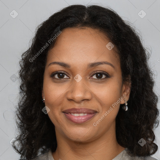 Joyful black young-adult female with long  brown hair and brown eyes