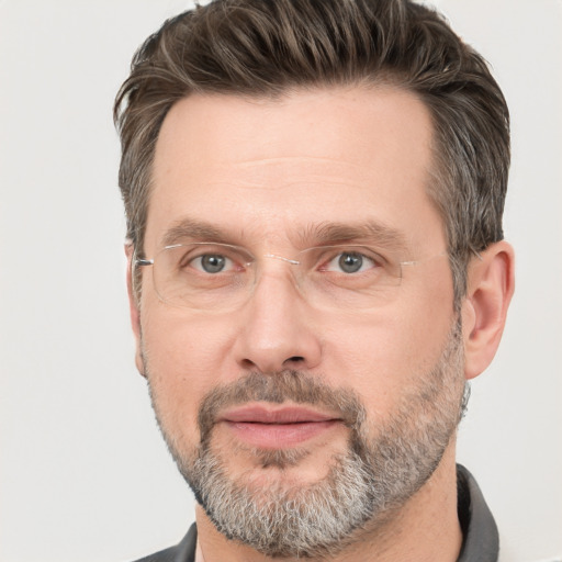 Joyful white adult male with short  brown hair and grey eyes