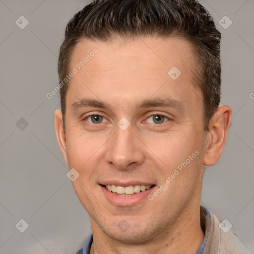 Joyful white adult male with short  brown hair and brown eyes