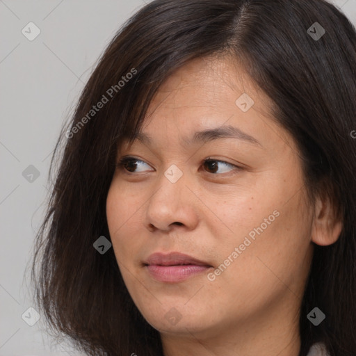 Joyful asian young-adult female with long  brown hair and brown eyes