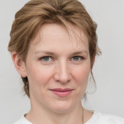 Joyful white young-adult female with medium  brown hair and blue eyes