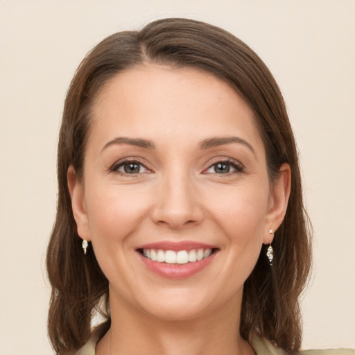 Joyful white young-adult female with long  brown hair and grey eyes