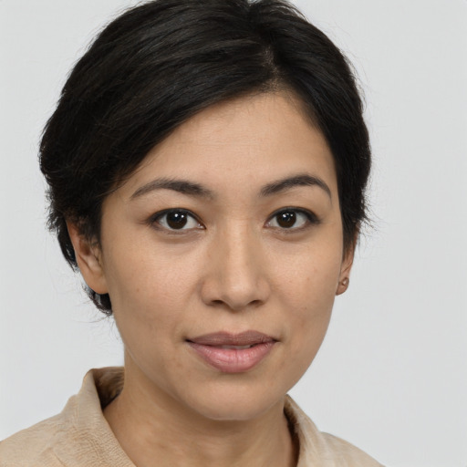 Joyful asian young-adult female with medium  brown hair and brown eyes
