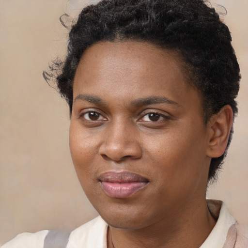 Joyful black young-adult female with short  brown hair and brown eyes