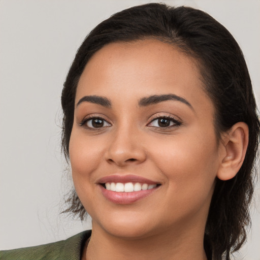 Joyful white young-adult female with long  brown hair and brown eyes