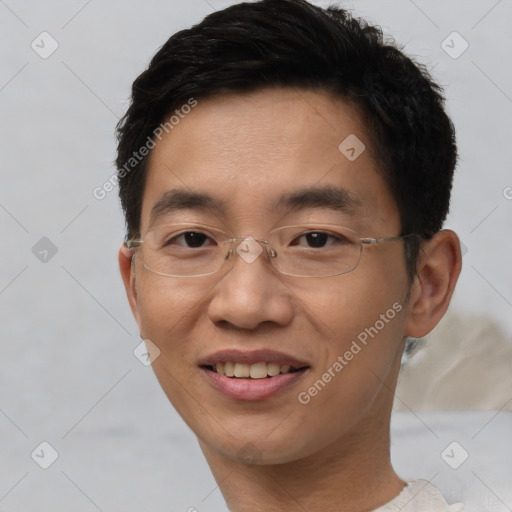 Joyful asian adult male with short  brown hair and brown eyes