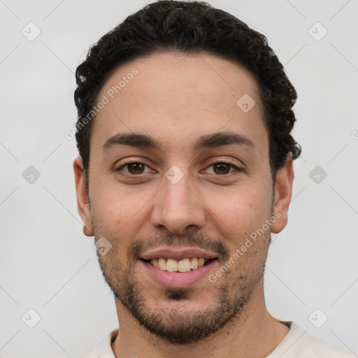 Joyful white young-adult male with short  black hair and brown eyes