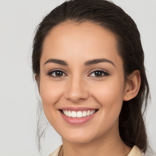 Joyful white young-adult female with long  brown hair and brown eyes