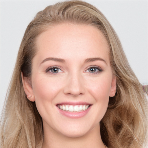 Joyful white young-adult female with long  brown hair and blue eyes