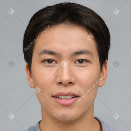 Joyful asian young-adult male with short  brown hair and brown eyes