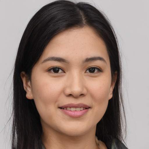 Joyful asian young-adult female with long  brown hair and brown eyes