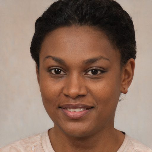 Joyful black young-adult female with short  brown hair and brown eyes