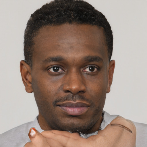 Neutral black young-adult male with short  brown hair and brown eyes