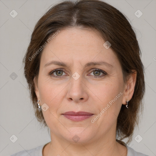 Joyful white adult female with medium  brown hair and grey eyes