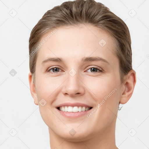 Joyful white young-adult female with short  brown hair and grey eyes