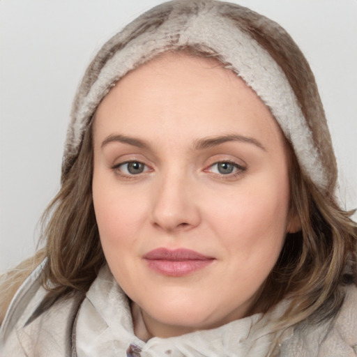 Joyful white young-adult female with medium  brown hair and blue eyes