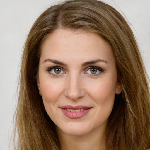 Joyful white young-adult female with long  brown hair and green eyes