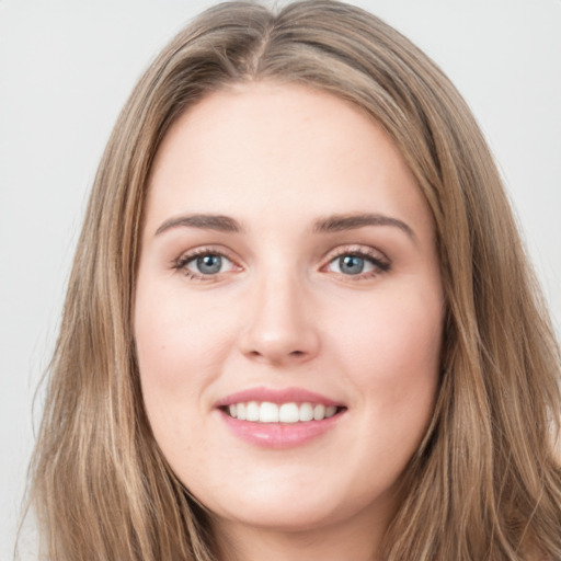 Joyful white young-adult female with long  brown hair and green eyes