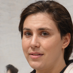 Joyful white adult female with medium  brown hair and brown eyes