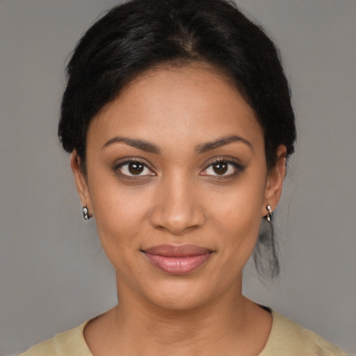 Joyful black young-adult female with medium  brown hair and brown eyes