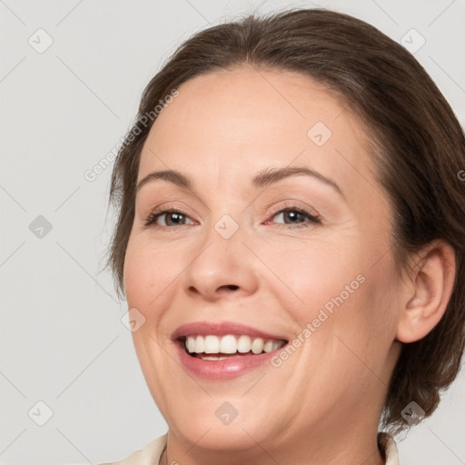 Joyful white adult female with medium  brown hair and brown eyes