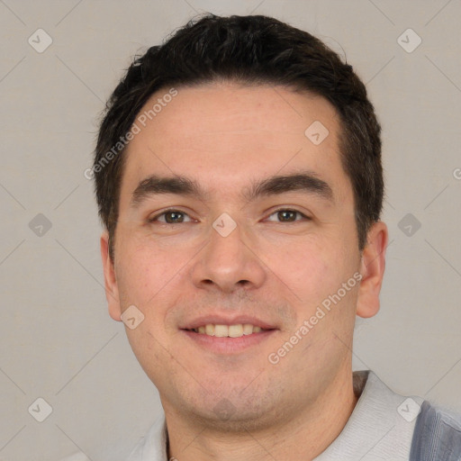 Joyful white young-adult male with short  black hair and brown eyes