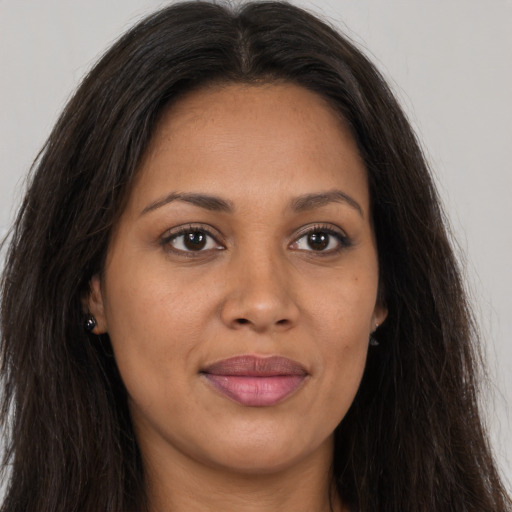 Joyful latino young-adult female with long  brown hair and brown eyes
