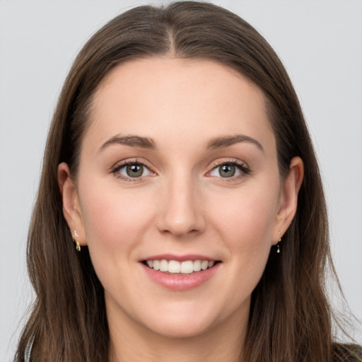 Joyful white young-adult female with long  brown hair and grey eyes