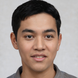 Joyful asian young-adult male with short  black hair and brown eyes