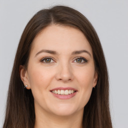 Joyful white young-adult female with long  brown hair and brown eyes