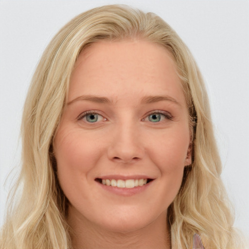 Joyful white young-adult female with long  brown hair and blue eyes