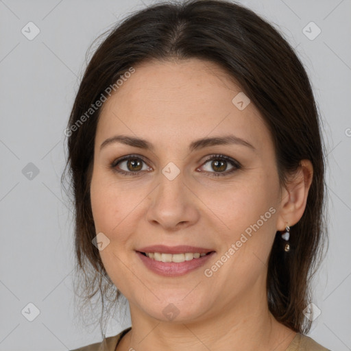 Joyful white adult female with medium  brown hair and brown eyes