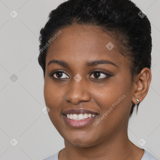 Joyful black young-adult female with short  brown hair and brown eyes