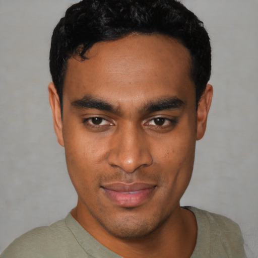 Joyful latino young-adult male with short  black hair and brown eyes