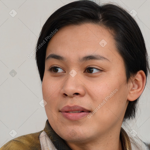 Joyful latino young-adult female with medium  brown hair and brown eyes