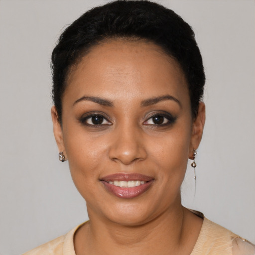 Joyful latino young-adult female with short  black hair and brown eyes