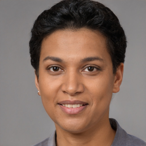 Joyful white young-adult female with short  black hair and brown eyes