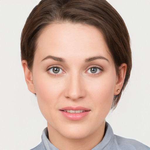 Joyful white young-adult female with short  brown hair and grey eyes