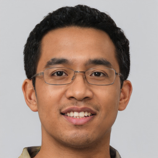 Joyful latino young-adult male with short  black hair and brown eyes