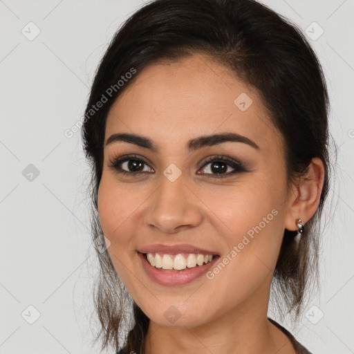 Joyful white young-adult female with long  brown hair and brown eyes