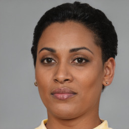 Joyful black young-adult female with short  brown hair and brown eyes