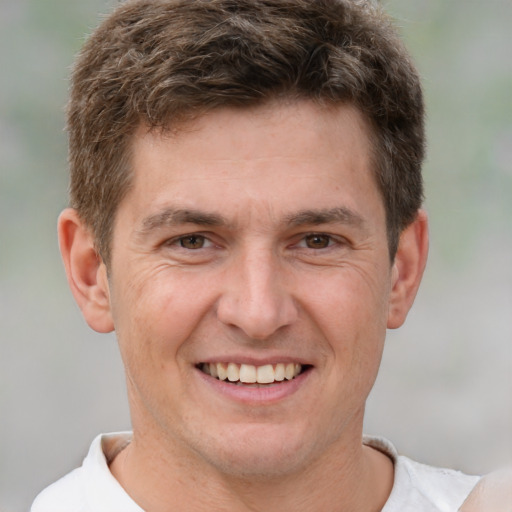 Joyful white adult male with short  brown hair and brown eyes