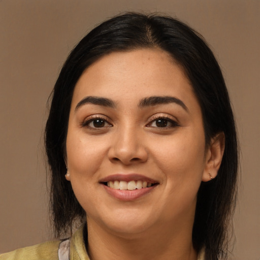 Joyful latino young-adult female with medium  brown hair and brown eyes