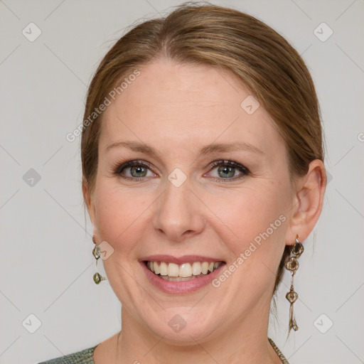 Joyful white adult female with medium  brown hair and blue eyes