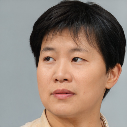 Joyful asian adult female with short  brown hair and brown eyes